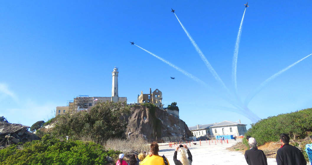 Tourists walking the grounds of Alcatraz Island visitors air show